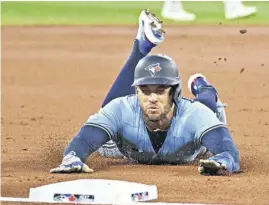  ?? DAN HAMILTON ■ USA TODAY SPORTS ?? Toronto Blue Jays’ George Springer dives into third base during a game against the Oakland Athletics in Toronto in April. Springer says the team needs a sense of urgency after a recent batting slump.