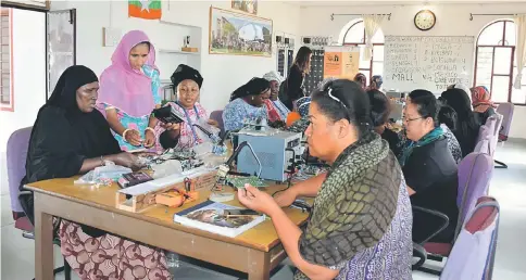  ??  ?? Engineer Magan Kawar (standing, second left) who left school after third grade, teaches a class of internatio­nal students in solar technology. Kawar has trained 900 women from over 20 countries. —IPS photos by Stella Paul