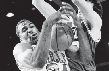  ?? Chicago Tribune file photo ?? Charles Oakley, left, formerly of the Chicago Bulls, battles Kevin McHale of the Celtics for rebound in 1987.