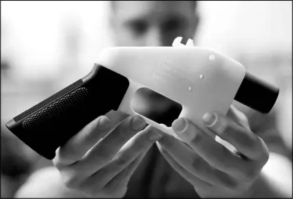  ?? ERIC GAY / ASSOCIATED PRESS ?? Cody Wilson, with Defense Distribute­d, holds a 3D-printed gun called the Liberator at his shop in Austin, Texas. Eleven states have joined eight others and the District of Columbia in a federal lawsuit that seeks to block a settlement the Trump administra­tion reached with a company that wants to post online plans to make 3D firearms on a printer.