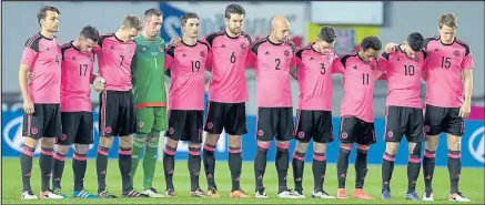  ??  ?? SOLEMN MOMENT: Scotland line up for a minute’s silence before Thursday’s game to pay respect to Johan Cruyff, above