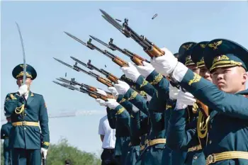  ?? — AFP ?? Kyrgyz honour guard soldiers fire a salute at the Eternal Flame monument during Victory Day celebratio­ns in Bishkek.