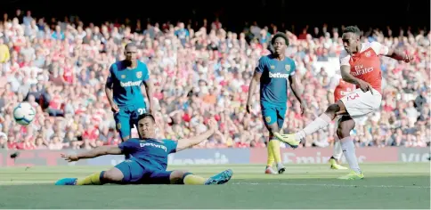  ??  ?? Arsenal’s English striker Danny Welbeck (right) scores their third goal during the English Premier League football match between Arsenal and West Ham United at the Emirates Stadium in London. — AFP photo