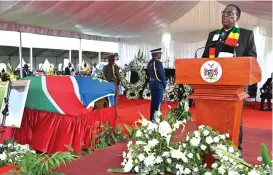  ?? ?? President Mnangagwa addresses mourners while standing next to a casket bearing the body of President Hage Geingob, which was draped with the Namibian national flag. — Pictures: Presidenti­al photograph­er Joseph Nyadzayo