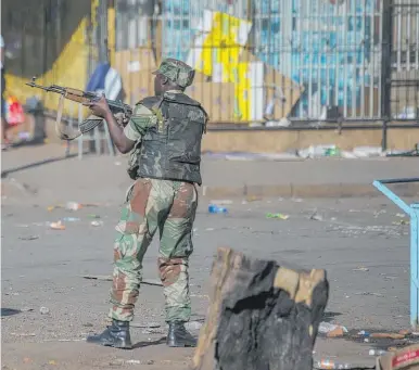  ?? Photo / AP ?? Armed soldiers took to the streets of Harare yesterday to break up protests by opposition supporters.