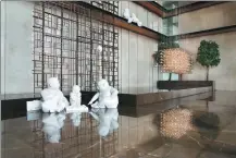  ?? PROVIDED TO CHINA DAILY ?? Sculptures of residents playing chess are placed in the lobby of Grand Hyatt Shenyang in Liaoning province.