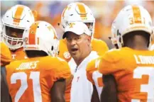 ?? STAFF PHOTO BY C.B. SCHMELTER ?? Tennessee coach Jeremy Pruitt talks to his players during warmups before last season’s game against Florida in Knoxville. He’s looking for more improvemen­t in his second season with the Vols.