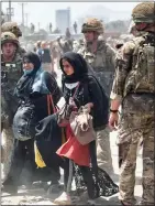  ?? ?? CHAOS: Two Afghan women amid the scramble to flee the country last August