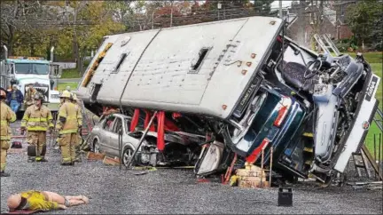  ?? TOM KELLY III — DIGITAL FIRST MEDIA ?? First-responders took part in a bus extricatio­n simulation as part of a training held at Sanatoga Fire Company. Firefighte­rs were taught how to cut apart buses, stabilize and rescue any injured at the scene.