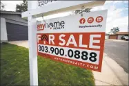  ?? Associated Press ?? A for sale sign outside a home in the Denver suburb of Thornton, Colo. Higher borrowing costs have raised monthly payments for new buyers, on top of rising home prices, a new report shows.
