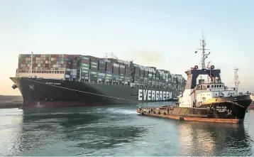  ?? Suez Canal Authority via AP ?? ■ The Ever Given, a Panama-flagged cargo ship, is pulled by one of the Suez Canal tugboats in the Suez Canal, Egypt, on Monday. Engineers on Monday “partially refloated” the colossal container ship, authoritie­s said.