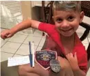  ?? ERIN MARIE/COURTESY ?? Dominic Marie shows off his youth police badge, which was given to him by Pembroke Pines Officer Robert Scopa.