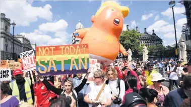  ??  ?? NOT WELCOME Protesters join the ‘Trump Baby’ balloon in London’s Parliament Square