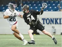  ?? PAUL W. GILLESPIE/STAFF ?? Army’s Reese Burek moves the ball around Navy’s Jackson Peters in the first quarter during last year’s matchup.