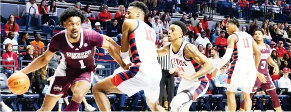  ?? ?? Mississipp­i State’s Tolu Smith (1) drives toward the lane against Theo Akwuba (10) of Ole Miss during Saturday’s game in Oxford. (Photo by Cal Brown, SDN)