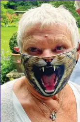  ??  ?? Roaring success: Judi Dench in wildcat mask at her partner’s animal sanctuary