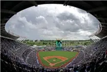  ?? AP PHOTO/CHARLIE RIEDEL ?? In 2017, clouds gather over Kauffman Stadium before a baseball game between the Kansas City Royals and the Cleveland Indians in Kansas City, Mo.
