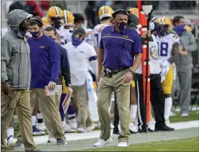  ?? MICHAEL WOODS — THE ASSOCIATED PRESS ?? LSU coach Ed Orgeron walks on the sidelines against Arkansas during the second half of an NCAA college football game Saturday, Nov. 21, 2020, in Fayettevil­le, Ark.