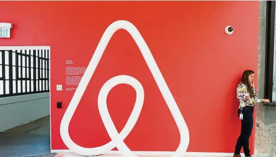  ??  ?? Digital economy: A woman talking on the phone at the Airbnb office headquarte­rs in San Francisco. Private homes in Singapore are currently subject to a minimum rental period of three consecutiv­e months, and such strict rules make the city-state one of...