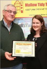  ??  ?? Brendan O’ Shea making a presentati­on to Eleanor Fitzpatric­k of Joyce’s Pharmacy.