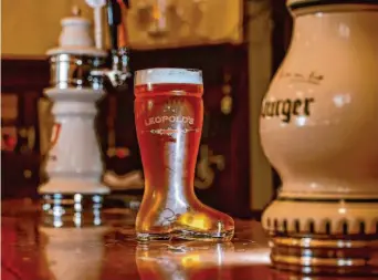  ?? Photos by Felix Uribe/Special to The Chronicle ?? A freshly poured beer in a boot-shaped glass at Leopold’s in San Francisco. The restaurant, which features authentic Austrian cuisine, is back with new ownership and a fresh look.