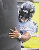  ?? KARL MERTON FERRON/BALTIMORE SUN ?? Rain flies as Ravens cornerback Marlon Humphrey hits a dummy at the team’s training facility on Wednesday.