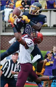  ?? AP PHOTO ?? East Carolina’s Trevon Brown (88) grabs the ball over Virginia Tech’s Greg Stroman (3) during the first half of an NCAA college football game in Greenville, N.C.