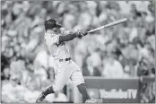  ?? HARRY HOW — GETTY IMAGES ?? Jose Altuve of the Houston Astros hits a solo home run during the 10th inning against the Los Angeles Dodgers in Game 2of the World Series at Dodger Stadium.