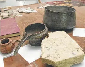  ?? Murad Sezer / Associated Press ?? Artifacts are seen on a table at the Iraqi National Museum in Baghdad after they were recovered after the orgy of looting that followed the fall of Saddam Hussein.