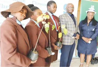  ?? ?? Zimpapers Editorial Executive
Mr William Chikoto and Public Relations Manager Pauline Matanda pose for a picture with Eveline High
School pupils after handing over trees to them at the Zimpapers Junior Media Club worshop at NUST
on Friday