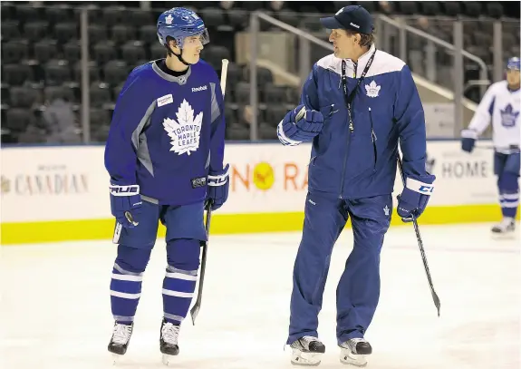  ?? JACK BOLAND / POSTMEDIA NETWORK ?? Toronto Maple Leafs rookie Mitch Marner chats with head coach Mike Babcock during a recent practice. Marner, part of the outstandin­g rookie corps that has the team’s rebuild ahead of schedule, ought not to be considered trade material, writes the...