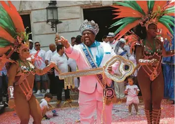  ?? BRUNA PRADO/AP ?? Key figure: Carnival King Momo, Djferson Mendes da Silva, holds the key to the city Friday at the official start of Carnival in Rio de Janeiro. Some 46 million people across Brazil are expected to join the festivitie­s, which continue into next week.
