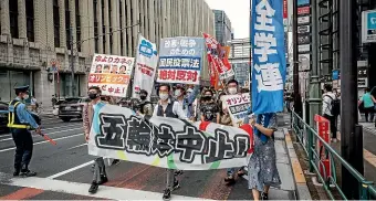  ?? AP ?? As Japan endures a fourth wave of coronaviru­s, protesters in Tokyo march towards the metropolit­an government building during a demonstrat­ion against the Tokyo Olympic Games.