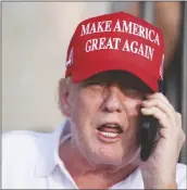  ?? REBECCA BLACKWELL/AP ?? REPUBLICAN PRESIDENTI­AL CANDIDATE, FORMER PRESIDENT DONALD TRUMP speaks on the phone as he watches play in the final round of LIV Golf Miami, at Trump National Doral Golf Club on Sunday in Doral, Fla.