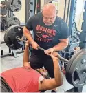 ?? RICK CANTU/AMERICAN-STATESMAN ?? Manor football coach James Keller spots for JT Thomas inside the weight room Tuesday. Thomas, the valedictor­ian of the senior class, will go to the Air Force Academy in the fall.