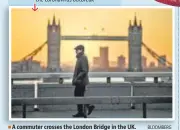  ?? BLOOMBERG ?? A commuter crosses the London Bridge in the UK.