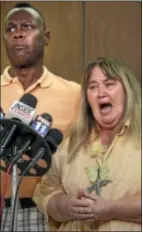  ?? AP Photo ?? Michael Wade (left) and his wife, Karen Patterson, react after a jury delivered a second degree murder verdict for their friend, David Viens.