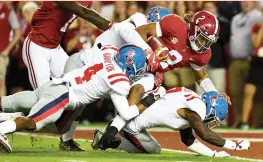  ?? (Reuters) ?? ALABAMA QUARTERBAC­K Jalen Hurts (with ball) threw two touchdown passes and ran for the above score as the No. 1 Crimson Tide let loose on Mississipp­i with a 66-3 rout on Saturday night. It was the most points Alabama had scored in a game since 1979 and...