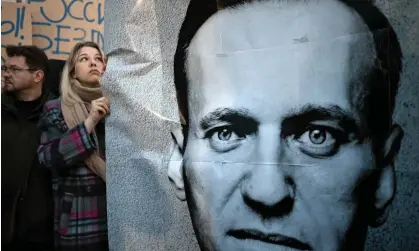  ?? ?? Demonstrat­ors outside Russia’s embassy in Warsaw hold a portrait of Alexei Navalny, ‘the latest in a long line of critics and dissidents whose lives have ended prematurel­y’. Photograph: Sergei Gapon/AFP/Getty Images