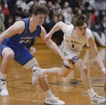  ?? LIBBY O’NEILL — BOSTON HERALD ?? Jake Fortier of St. Mary’s avoids the coverage of Dover-Sherborn’s Brian Olson during the first half. Dover-Sherborn earned a thrilling 47-46 state tournament win Friday.