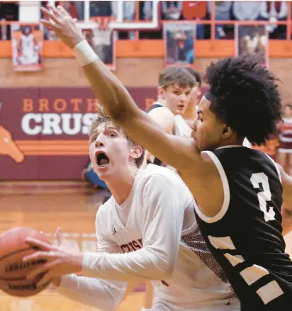  ?? SOUTHTOWN JOHN SMIERCIAK/DAILY ?? Brother Rice’s Caden Workman, left, looks at the basket as Mount Carmel’s Noah Mister goes in for the block on Friday.