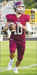  ??  ?? Gentry junior Zach Jarnagan, quarterbac­k for the Pioneers, looks for an open receiver.