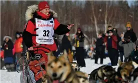  ?? Photograph: Marc Lester/Reuters ?? Aliy Zirkle, greets fans as she passes by the Iditarod sled dog race starting area on Sunday on a course drasticall­y altered by the coronaviru­s pandemic at Deshka Landing in Willow, Alaska.