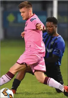  ??  ?? Liam McCartan in action against George Mukete of Athlone Town .