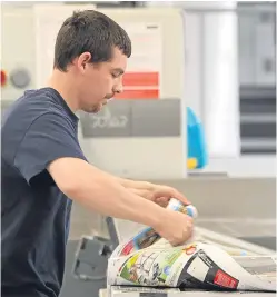  ?? Picture: Kris Miller. ?? A Tradeprint technician checks print proofs.