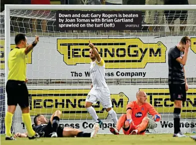  ?? SPORTSFILE ?? Down and out: Gary Rogers is beaten by Joan Tomas with Brian Gartland sprawled on the turf (left)