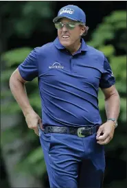  ?? FRANK FRANKLIN II — THE ASSOCIATED PRESS ?? Phil Mickelson looks on after putting on the 14th green during the second round of the Travelers Championsh­ip golf tournament at TPC River Highlands on Friday in Cromwell, Conn.