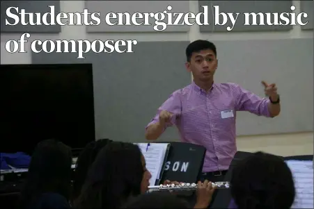  ?? WILLIAM ROLLER PHOTO ?? Benjamin Yeo, composer/conductor and instructor at the Anglo-Chinese School in Singapore, leads the Wilson Junior High School Band in his compositio­n commission­ed by the school in its band room on Wednesday in preparatio­n for the Concert of Premieres....