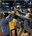  ?? DREW ELLIS — MEDIANEWS GROUP ?? Jacqui Feldman, the daughter of Marian Athletic Director David Feldman, presents the Division 1state championsh­ip trophy to Marian volleyball Saturday. David Feldman passed away Thursday night after a lengthy battle with COVID-19.