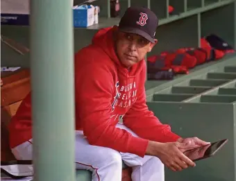  ?? MATT sTONE / hErAld sTAff ?? ‘KEEP MOVING FORWARD:’ Red Sox manager Alex Cora sits in the dugout before a game against the Toronto Blue Jays at Fenway Park on Monday.